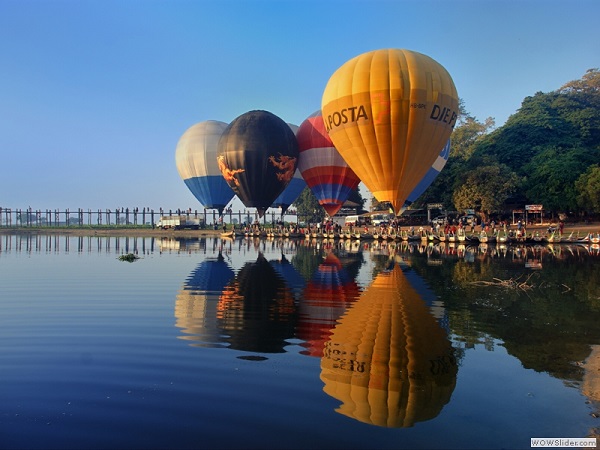 Baloons over U Bein bridge, Mandalay region, Myanmar photo