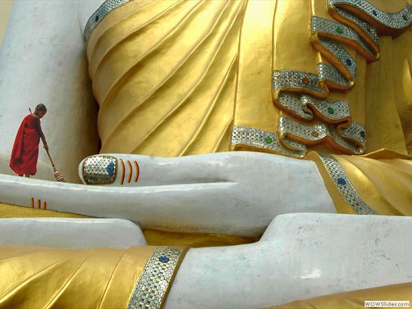 Cleaning a statue of the Buddha, Myanmar photo