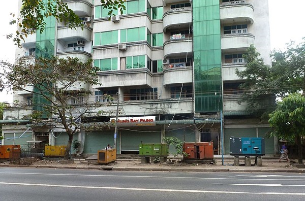 Electric generators in front of an apartment building, Yangon, Myanmar photo