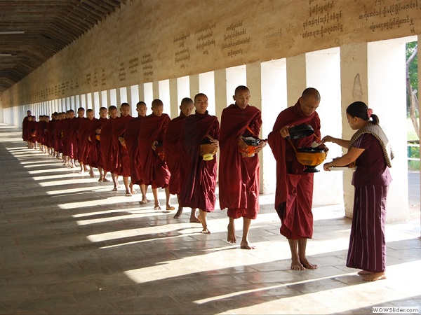 Offering rice to the monks, Mandalay, Myanmar photo